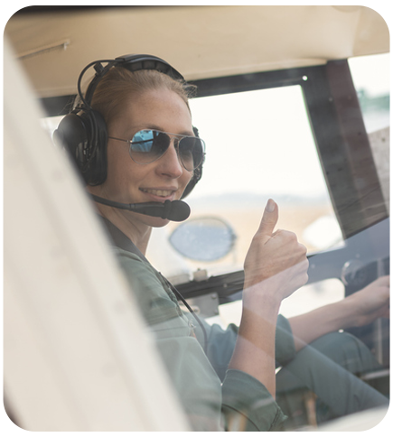 female pilot giving thumbs up